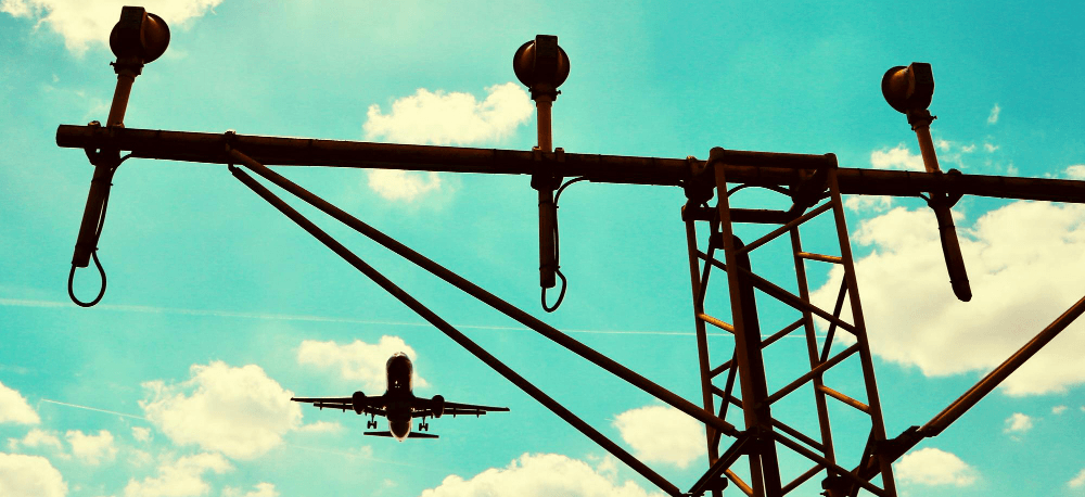 Airplane in the backdrop of a communication pole