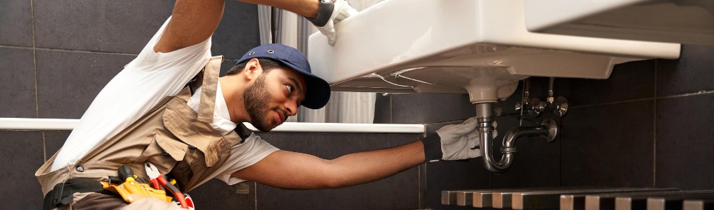 red seal plumber journeyman working A SINK