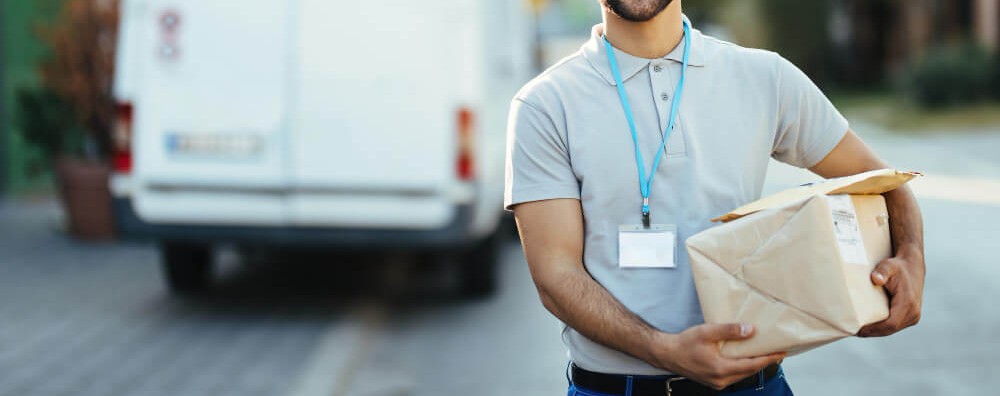 mail carrier outside his delivery car 