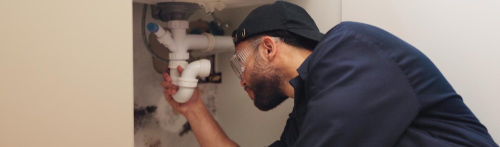 journeyman plumber working a sink
