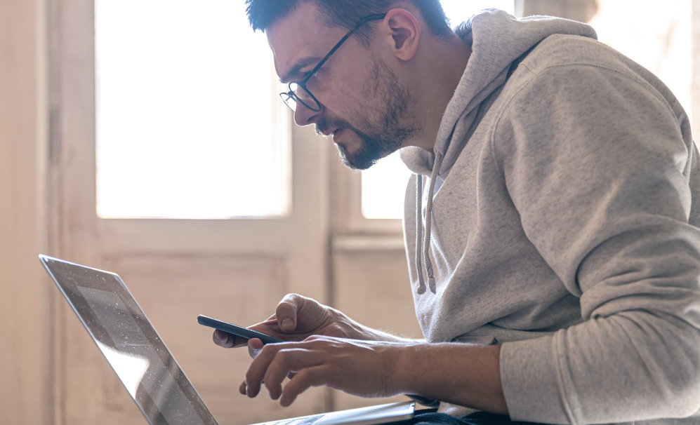 Man calculating his score on an online test