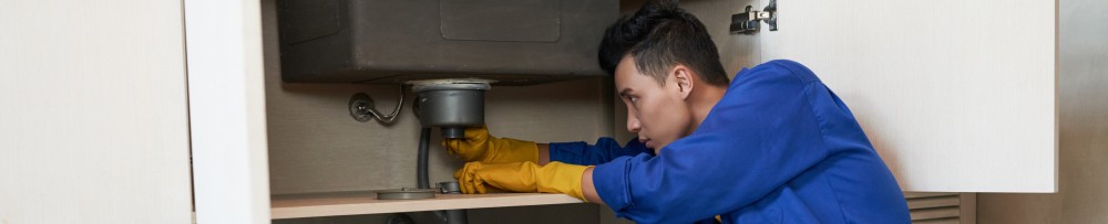 plumber journeyman at work kitchen